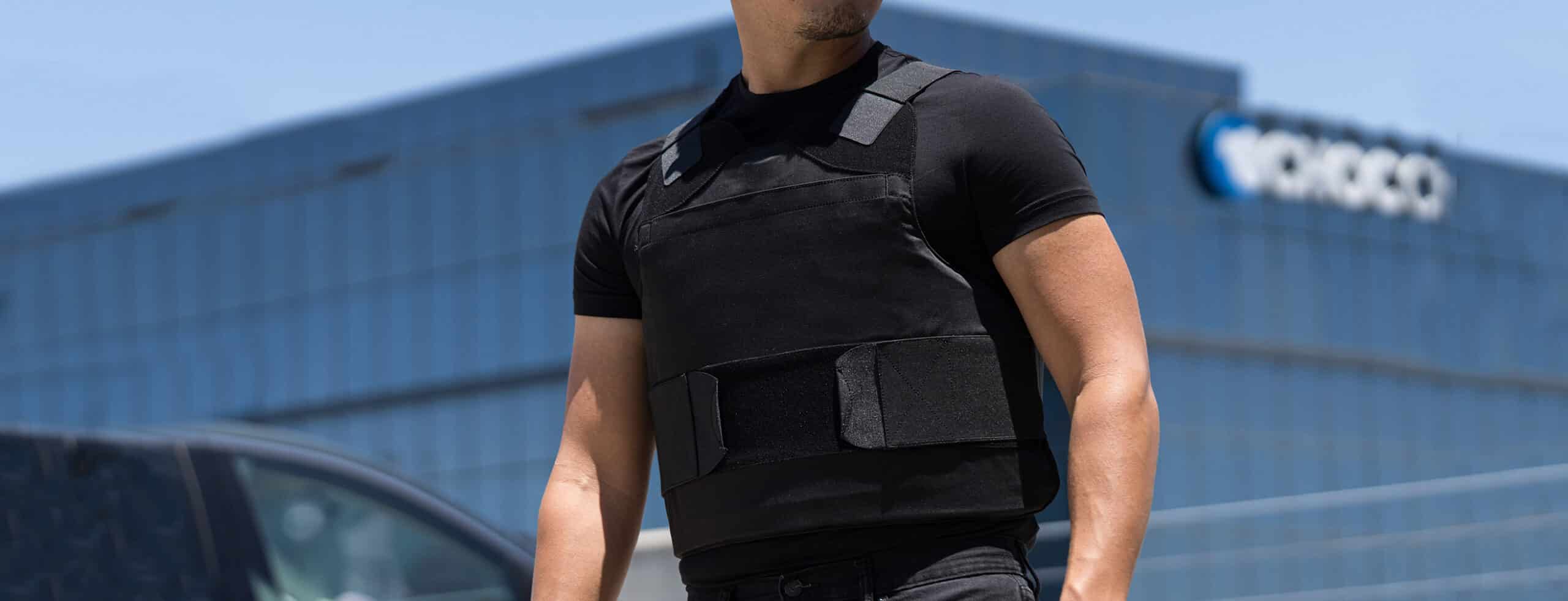 A man is standing in front of a building.